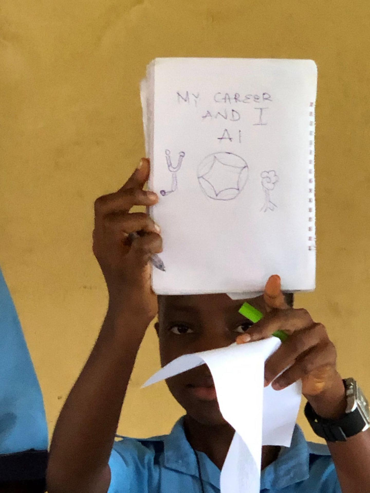 A student proudly holds up her notebook titled 'My Career and AI'